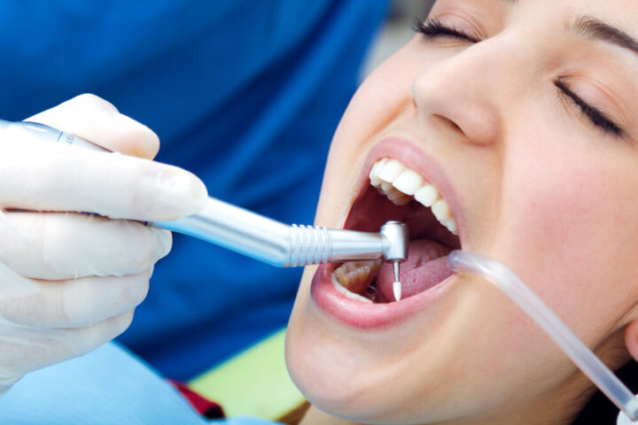 Oral surgery being performed by a dentist to remove an impacted tooth